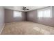 Spacious bedroom with neutral carpet, ceiling fan and natural light from the large grid-patterned windows at 2799 S Ingalls Way, Denver, CO 80227