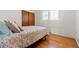 Cozy bedroom showcasing hardwood floors, a large closet, and a large window at 2799 S Ingalls Way, Denver, CO 80227