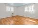Bright bedroom featuring hardwood floors, neutral walls, and two windows for ample light at 2799 S Ingalls Way, Denver, CO 80227