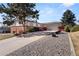 Beautiful shot of the home displaying the front lawn, driveway, and garage at 2799 S Ingalls Way, Denver, CO 80227