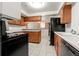 Functional kitchen featuring wood cabinets, a white countertop, and essential appliances for easy meal preparation at 2799 S Ingalls Way, Denver, CO 80227