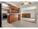 The kitchen features wood cabinets and tiled floors; the living room is visible in the background at 2799 S Ingalls Way, Denver, CO 80227