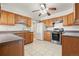 Spacious kitchen featuring wood cabinets, stainless steel appliances, and a tile floor at 2799 S Ingalls Way, Denver, CO 80227