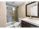 Bathroom featuring a modern sink and faucet, glass shower doors, tiled shower and modern fixtures at 4400 S Quebec St # 108L, Denver, CO 80237