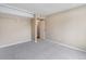 This bedroom has light grey carpets, neutral walls, closet, and a door to another room at 4400 S Quebec St # 108L, Denver, CO 80237