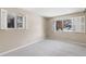 This bedroom has light grey carpet, neutral walls, and windows with shutters for natural light at 4400 S Quebec St # 108L, Denver, CO 80237