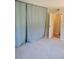 Carpeted bedroom featuring a large wardrobe concealed behind curtains at 4400 S Quebec St # 108L, Denver, CO 80237