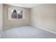 Bright, carpeted bedroom featuring one window dressed with white shutters at 4400 S Quebec St # 108L, Denver, CO 80237