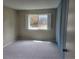 Bright bedroom featuring neutral walls, carpet, and a window with natural light at 4400 S Quebec St # 108L, Denver, CO 80237