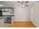 Bright dining area features wood floors, a modern ceiling fan and access to kitchen at 4400 S Quebec St # 108L, Denver, CO 80237