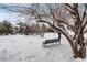 Community outdoor space with a bench and snowy views of the property at 4400 S Quebec St # 108L, Denver, CO 80237