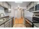 Modern kitchen with stainless steel appliances, hardwood floors in the foreground and gray cabinets at 4400 S Quebec St # 108L, Denver, CO 80237
