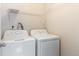 Laundry room with white washer and dryer, and wire shelving for convenient storage at 4400 S Quebec St # 108L, Denver, CO 80237