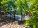 Community pool area featuring a secure fence, seating, landscaping, and mature trees at 4400 S Quebec St # 108L, Denver, CO 80237