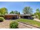 Charming backyard featuring a covered patio area and well-maintained lawn, perfect for relaxation at 4953 W 61St Ave, Arvada, CO 80003