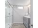 Modern bathroom featuring a glass-enclosed shower and gray vanity with quartz countertop at 4953 W 61St Ave, Arvada, CO 80003