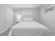 This well-lit bedroom features a large bed, light colored walls and floors, and a bedside table at 4953 W 61St Ave, Arvada, CO 80003