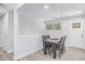 Clean and inviting dining area featuring a modern table and chairs, bathed in natural light from a nearby window at 4953 W 61St Ave, Arvada, CO 80003
