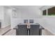 Dining room with stylish table, black leather chairs, and neutral-toned walls with natural light at 4953 W 61St Ave, Arvada, CO 80003