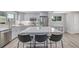 Spacious kitchen featuring a large island with seating, stainless steel appliances, and light gray cabinetry at 4953 W 61St Ave, Arvada, CO 80003
