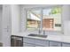 Bright kitchen featuring stainless appliances, stone countertops, and a large window with backyard views at 4953 W 61St Ave, Arvada, CO 80003