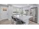 Stylish kitchen featuring a large island with seating, stainless steel appliances, and light gray cabinetry at 4953 W 61St Ave, Arvada, CO 80003
