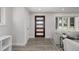 Bright living room featuring modern gray decor, and a view of the front door at 4953 W 61St Ave, Arvada, CO 80003