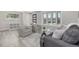 Bright living room featuring modern gray decor, bay window, and plenty of natural light at 4953 W 61St Ave, Arvada, CO 80003