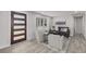 Bright living room featuring modern gray decor, a bay window, and stylish front door at 4953 W 61St Ave, Arvada, CO 80003