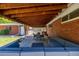 Spacious covered patio featuring a dining table and a comfortable outdoor sofa at 4953 W 61St Ave, Arvada, CO 80003