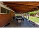Covered patio with exposed wood beams, outdoor seating, and backyard view at 4953 W 61St Ave, Arvada, CO 80003