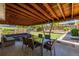 Covered patio with outdoor dining table and lounge area overlooking the backyard at 4953 W 61St Ave, Arvada, CO 80003