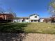 Spacious backyard featuring a well-maintained lawn, shed, and patio with room for outdoor entertaining at 4416 E 93Rd Pl, Thornton, CO 80229