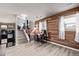 Finished basement with wood paneling, desk, staircase, and updated flooring for a functional living space at 4416 E 93Rd Pl, Thornton, CO 80229