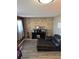 Cozy den featuring a rustic brick wall, comfortable seating and stylish decor at 4416 E 93Rd Pl, Thornton, CO 80229