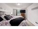 Comfortable bedroom featuring a plush bed, modern dresser, and large TV at 4416 E 93Rd Pl, Thornton, CO 80229