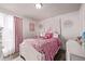Charming bedroom featuring a white four-poster bed with pink accents and a decorative rose theme at 4416 E 93Rd Pl, Thornton, CO 80229