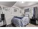Cozy bedroom decorated with sports themes, featuring a comfortable bed and ample lighting at 4416 E 93Rd Pl, Thornton, CO 80229