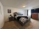 Spacious bedroom with a king-sized bed, dresser, and natural light from the window at 4416 E 93Rd Pl, Thornton, CO 80229
