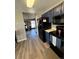 Efficient kitchen featuring dark appliances, wood flooring and access to other living areas in the home at 4416 E 93Rd Pl, Thornton, CO 80229