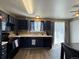 Updated kitchen featuring dark cabinets, modern appliances, a garden window and a sliding door to the backyard at 4416 E 93Rd Pl, Thornton, CO 80229