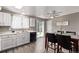 Bright kitchen with white cabinets, stainless steel sink, and a view to the backyard through sliding doors at 4416 E 93Rd Pl, Thornton, CO 80229