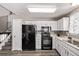 Functional kitchen design with white cabinets, black appliances, and modern flooring at 4416 E 93Rd Pl, Thornton, CO 80229