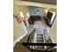A view from the upper level down to the living room with stylish floors and decor at 4416 E 93Rd Pl, Thornton, CO 80229