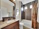 Bathroom features a combination tub and shower with tile surround at 5474 Espana St, Denver, CO 80249