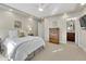 Bright bedroom features a ceiling fan, neutral walls, and ensuite bathroom access at 5474 Espana St, Denver, CO 80249