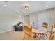 Bonus room featuring a table with chairs, a ceiling light, and a comfy chair at 5474 Espana St, Denver, CO 80249