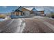 Community clubhouse exterior with a circular driveway and nicely landscaped grounds at 5474 Espana St, Denver, CO 80249