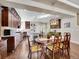 A dining room adjoins the kitchen, with a wooden dining table and matching cabinet at 5474 Espana St, Denver, CO 80249