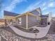 Exterior shot showcasing the home's siding, covered patio, and landscaping at 5474 Espana St, Denver, CO 80249